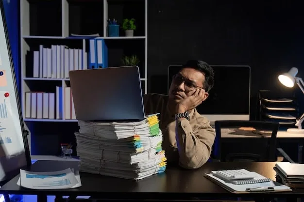 A person sitting at a desk looking stressed and overwhelmed, surrounded by piles of papers and a computer screen, with soft, diffused lighting.