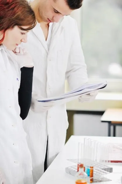A person wearing a blood pressure cuff, with a research scientist in the background taking notes on a clipboard. The setting is a clinical research lab with medical equipment visible.