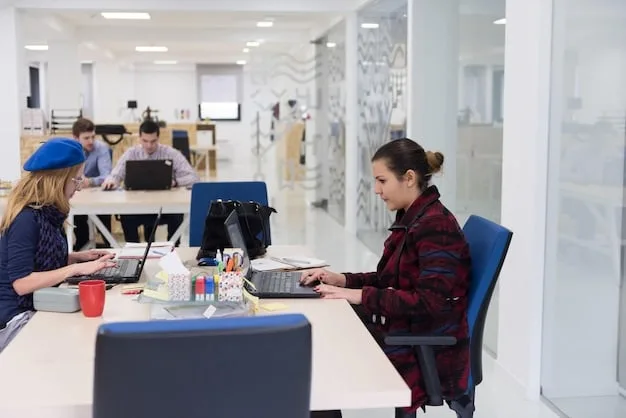 An open-plan office with large windows, adjustable workstations, and employees using blue-light filtering glasses while working on their computers. The lighting is warm and natural, creating a calming and productive atmosphere.