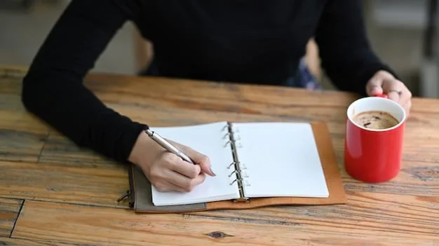 A person writing down goals on a notepad with a pen. The notepad is open, and the person is visible from the shoulders up, focusing on writing. The background is a clean, modern office setting with natural light.