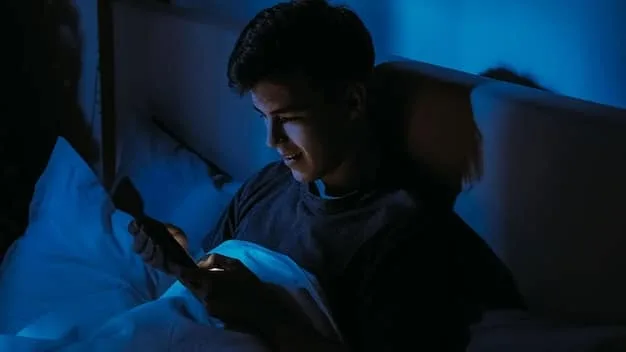 A person using a smartphone in bed late at night, with the blue light from the screen illuminating their face. The background is dark and the scene should convey a sense of isolation and sleep deprivation.