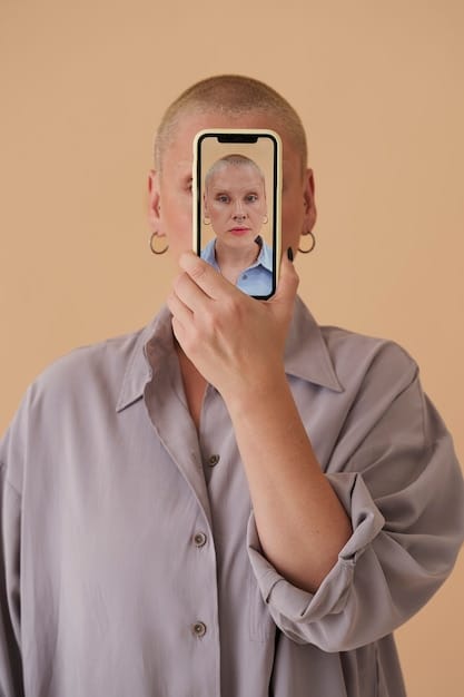 A person looking at their reflection in a phone screen with an unhappy expression. The reflection is distorted and exaggerated, emphasizing negative features.