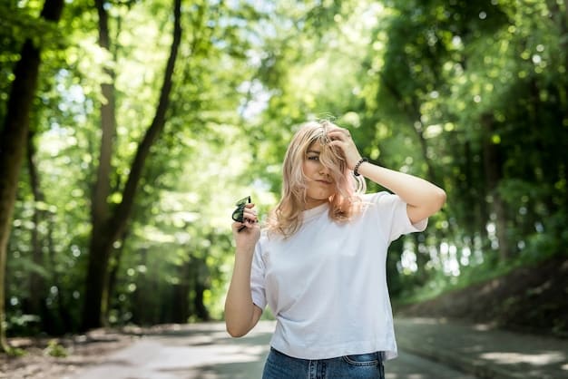 A person smiling while walking through a lush green park, looking relaxed and content.