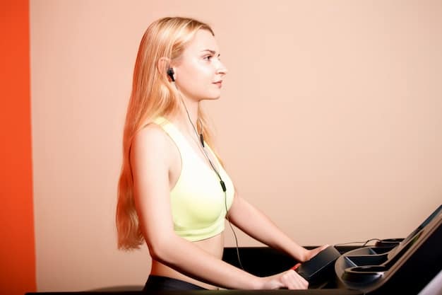 A person running on a treadmill in a brightly lit gym, focused and determined, with sweat visible on their forehead, showcasing the effort and dedication involved in exercising for mental health.