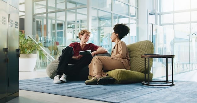 An individual in conversation with a therapist, seated comfortably in a brightly lit, welcoming office. Both are engaged in active listening, reflecting a supportive and empathetic therapeutic environment.