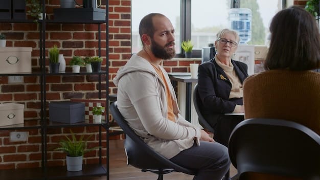 An employee talking openly with their manager about mental health concerns in a private office setting, with the manager listening attentively and offering support.