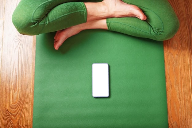 A close-up of a smartphone screen displaying a mindfulness app’s interface during a guided meditation session. The screen shows calming visuals, such as gentle ocean waves or a serene forest scene, along with instructions and timers.
