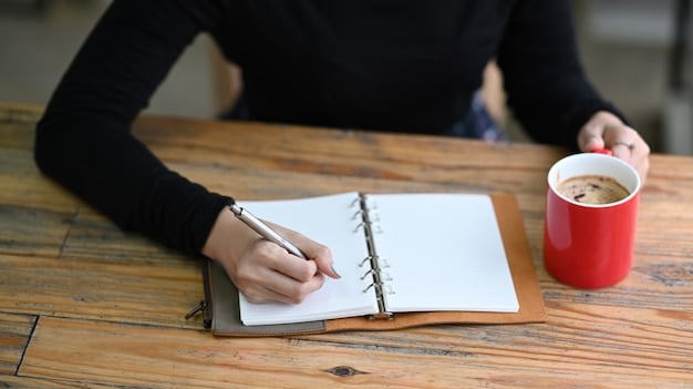 A person writing down goals on a notepad with a pen. The notepad is open, and the person is visible from the shoulders up, focusing on writing. The background is a clean, modern office setting with natural light.