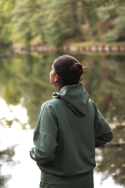 A person practicing mindful walking in nature, focusing on their breath and surroundings.