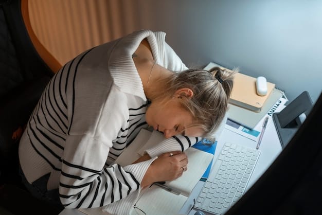 A person struggling to stay awake at a desk, highlighting the impact of sleep deprivation on alertness and cognitive function.