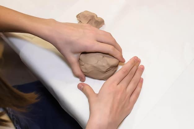 A close-up of hands gently molding clay into a form during an art therapy session, focusing on the tactile and calming nature of the activity.