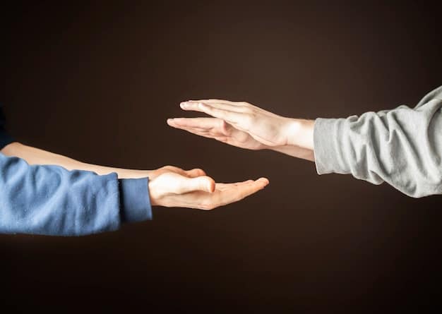 A person is shown reaching out their hand in support to another person who appears distressed. The background is blurred, emphasizing the connection and empathy between the two individuals. The lighting is warm, conveying a sense of hope and comfort.