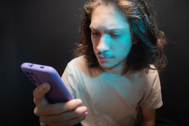 A close-up of a teenager's face, illuminated by the blue light of a smartphone. Their expression is one of worry and fatigue, with multiple social media notification icons visible on the screen.